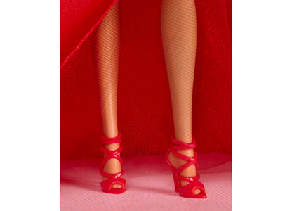 Barbie 2026 Holiday Doll wearing red gown with bow detail and fishnet stockings, red heeled shoes