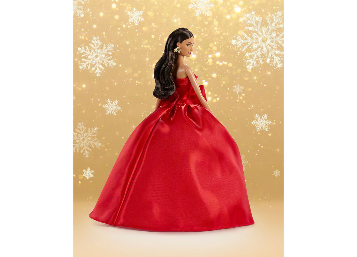 Barbie 2026 Holiday Doll in red ball gown with bow detail, long brown hair, and silver earrings against gold snowflak...