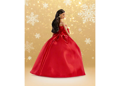 Barbie 2026 Holiday Doll in red ball gown with bow detail, long brown hair, and silver earrings against gold snowflak...