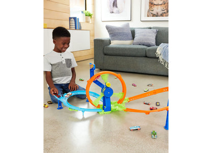 Hot Wheels Rapid Launch Loop Playset with blue and orange track, child playing with die-cast cars