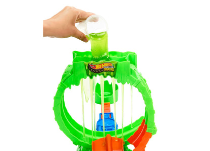 Hot Wheels Monster Trucks Mutant Chaos Loop playset with green slime being poured from cup