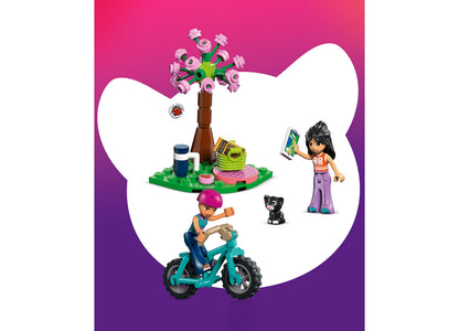 LEGO Friends Nature Glamping Cabin 42682 set with minifigures, bike, and pink flower tree