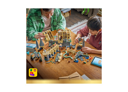 LEGO Harry Potter Hogwarts Castle East Wing set with adult and child building together at wooden table