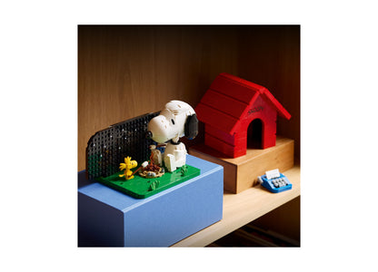 LEGO Peanuts Snoopy's Doghouse 21368 building set with red doghouse, white Snoopy figure, and yellow Woodstock