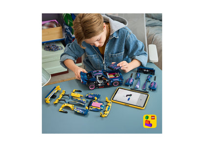 Girl building LEGO Ford Mustang GT Custom Garage set with blue and yellow mechanical parts and tablet