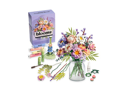 Play-Doh Blooms Meadow Bouquet kit with purple box, molding tools, colorful flowers in glass vase, and accessories