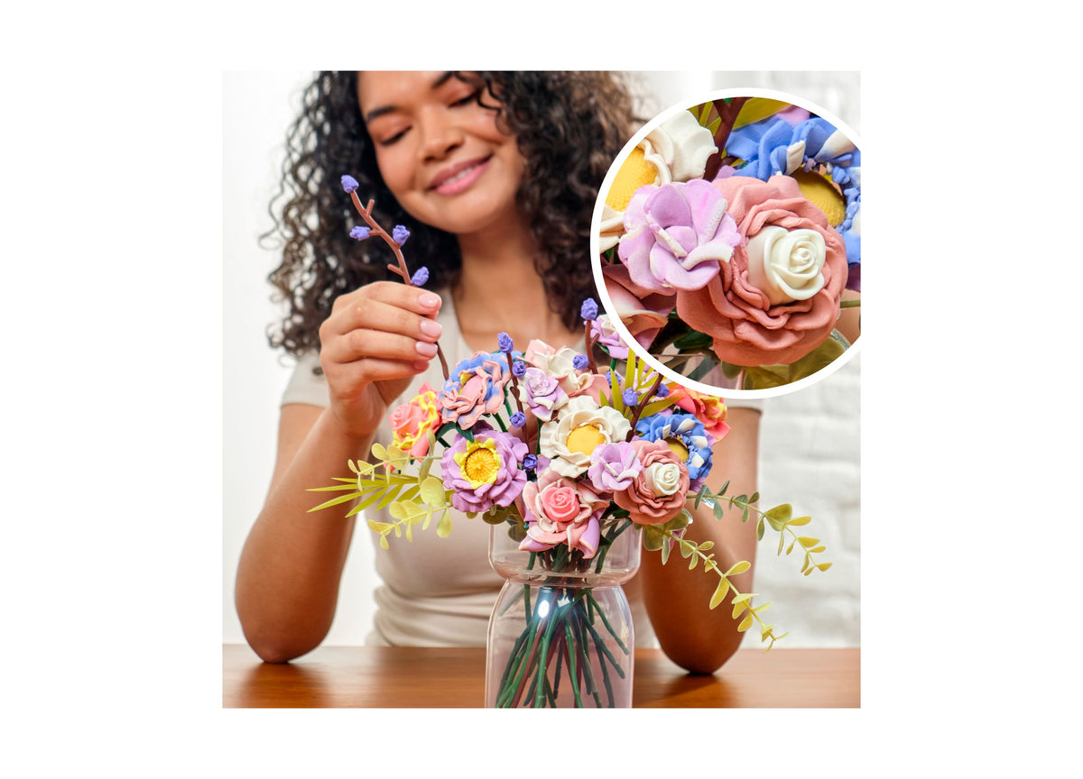 Play-Doh Blooms Meadow Bouquet Flower-Making Kit with colorful molded flowers in pink, purple, yellow, blue, and whit...