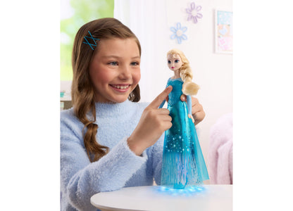 Girl holding Disney Princess Singing Elsa 11-inch light-up fashion doll in blue cape dress