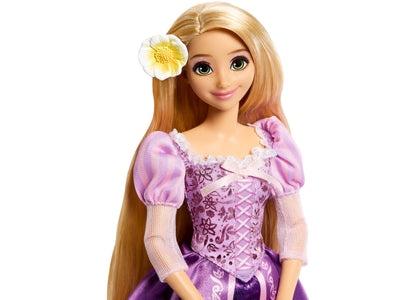 Disney Princess Rapunzel 13" doll wearing purple sparkly gown with puff sleeves, long golden hair, and white flower h...