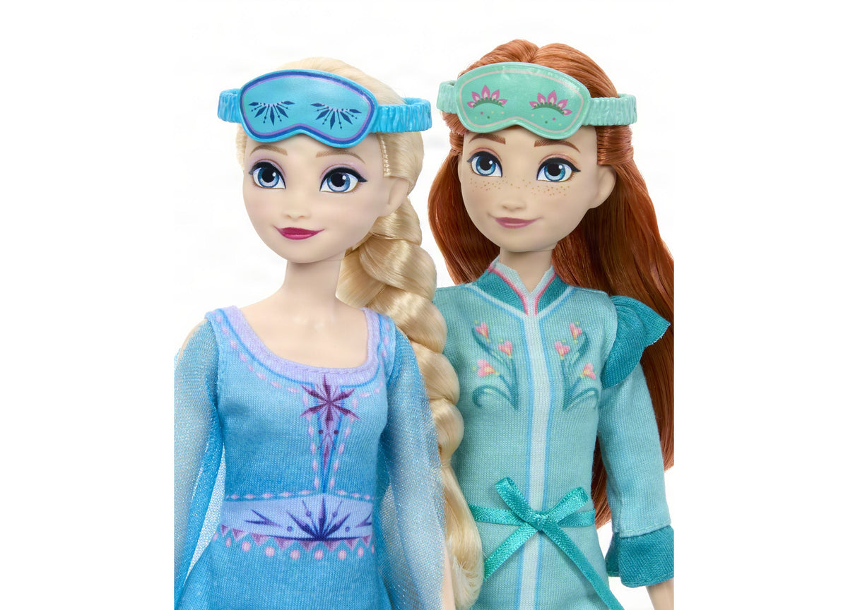 Disney Frozen Slumber Sister Set with posable Elsa and Anna dolls wearing blue and green nightgowns with eye masks