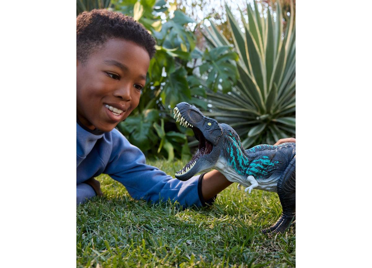 Jurassic World Muscle Madness Tyrannosaurus Rex 21.5-Inch Action Figure with blue and teal coloring, shown with child...