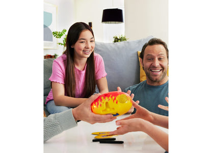 Pictionary Pic-Tato Hot Potato Drawing Game in red and yellow, held by two players during gameplay