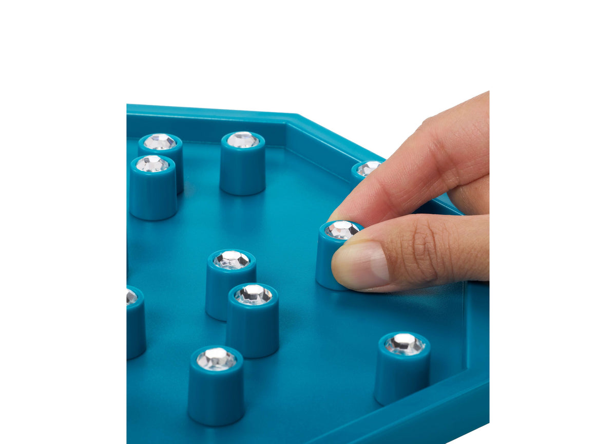 Mattel Deep Sea Diamond Dive board game with teal game board and gem pieces, hand reaching to grab a gem