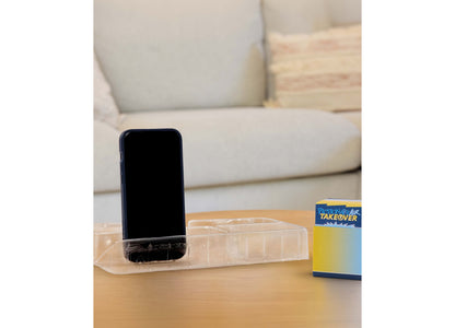 Mattel Pictionary Air Takeover drawing game box displayed on wooden table with phone stand