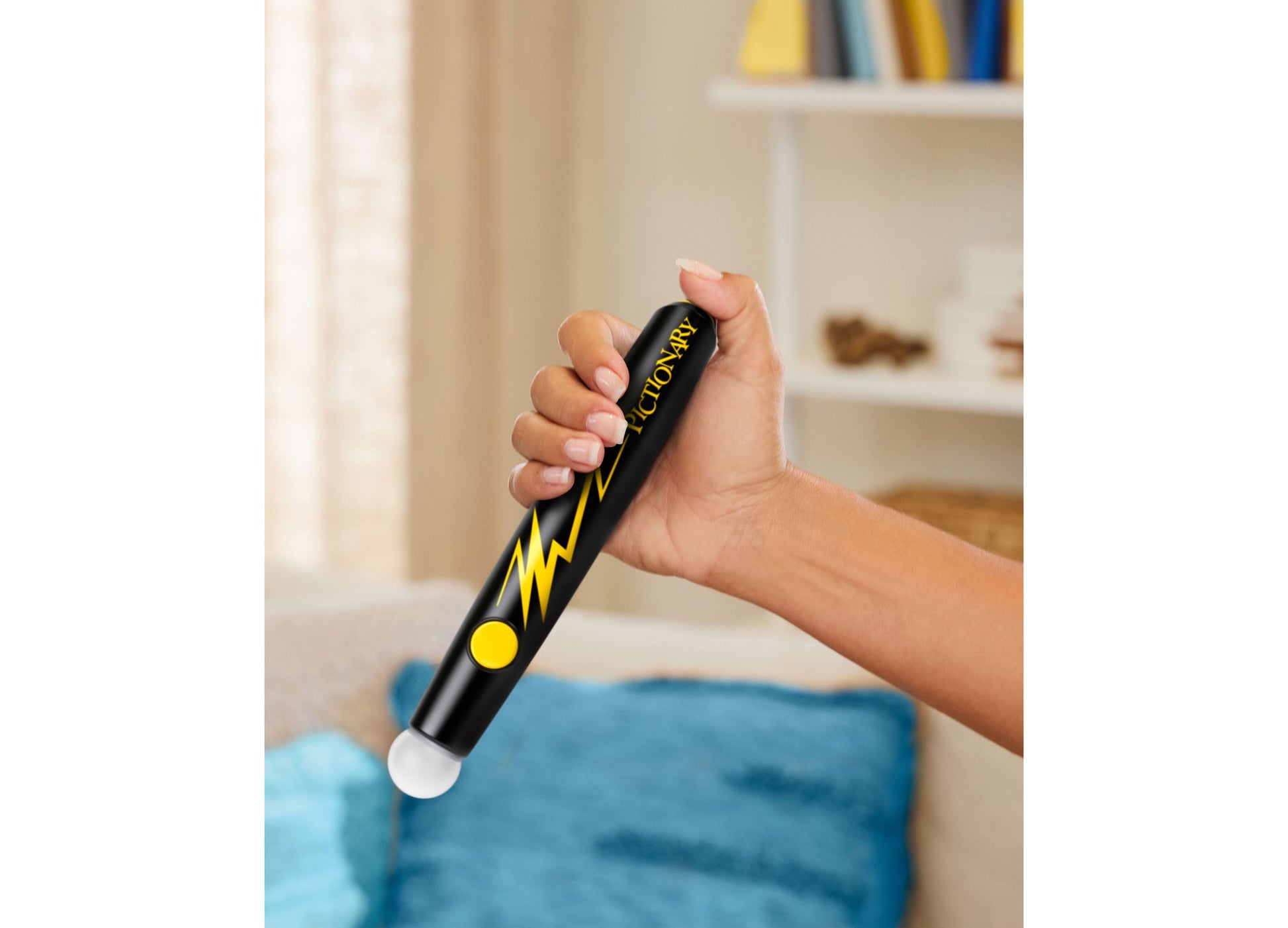 Child holding Mattel Pictionary Air Takeover drawing game with black pen and yellow lightning bolt design
