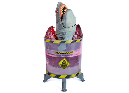 Primal Hatch Megalodon toy with glowing teeth emerging from purple containment pod with yellow warning stripes