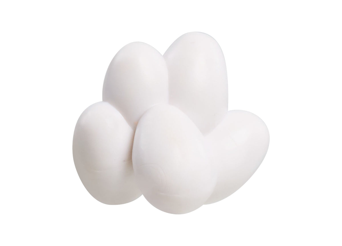 Four white egg-shaped toy pieces arranged together against a white background