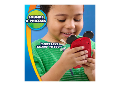 Child in green shirt holding red Mickey Mouse Clubhouse light-up interactive phone with black ears