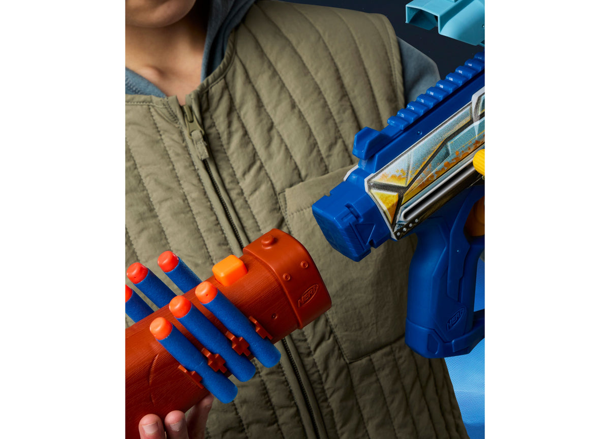 Child holding Nerf Star Wars Mandalorian Bolt-Action Blaster with red and blue dart cylinder and accessories
