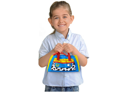 Child holding Imaginext Bullseye 9" Care Kit Plush with red handles and colorful cow print design