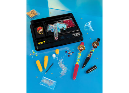 Make It Real Harry Potter Customizable Floaty Pens 3-Piece Set with sequins, charms, and decorative elements on blue ...