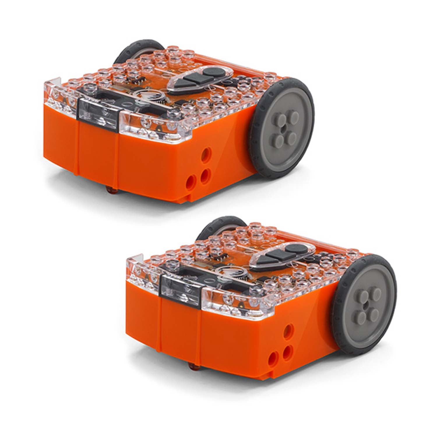 Two orange Edison STEAM robot kits with transparent tops showing internal circuits, black wheels, and control buttons