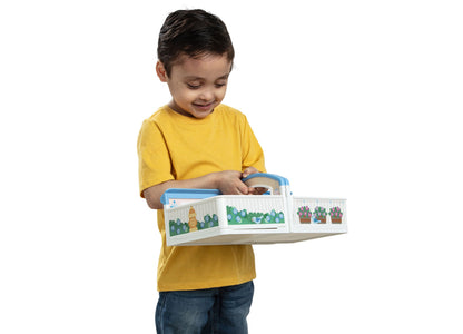 Child in yellow shirt playing with Melissa & Doug Cheery Lane Fold-Out Rooms House featuring four connected rooms wit...