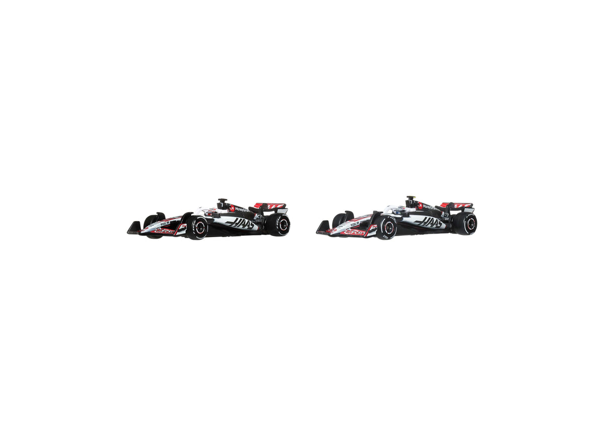 Hot Wheels 1:64 Scale MoneyGram Haas F1 Team 2-Pack die-cast race cars with black, red and white liveries on display ...