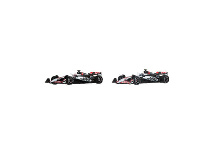 Hot Wheels 1:64 Scale MoneyGram Haas F1 Team 2-Pack die-cast race cars with black, red and white liveries on display ...