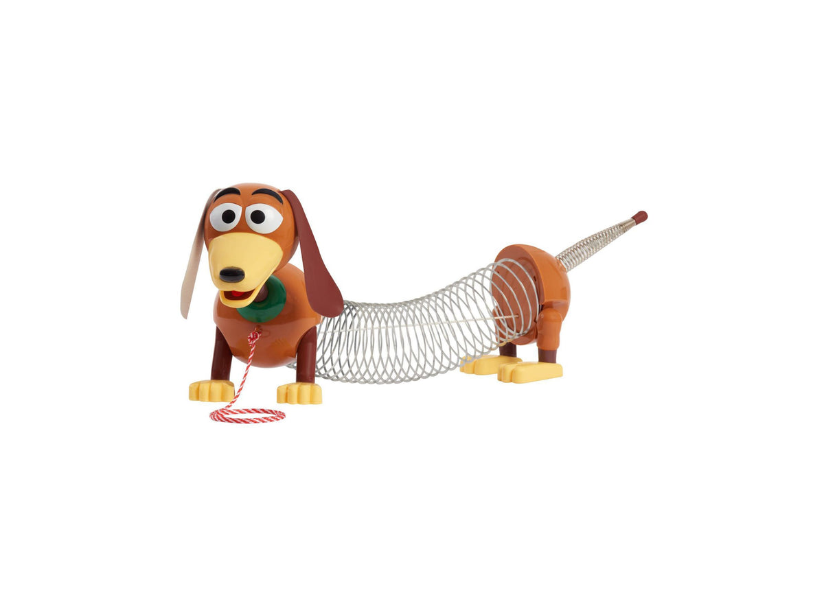 Toy Story Slinky Dog Pull Toy with brown body, yellow face, floppy ears, green collar, coiled midsection, and red-and...