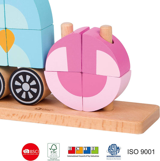 Pink wooden puzzle ball with light pink sections next to colorful wooden block train with blue cab, brown base, and wheel details on natural wood platform