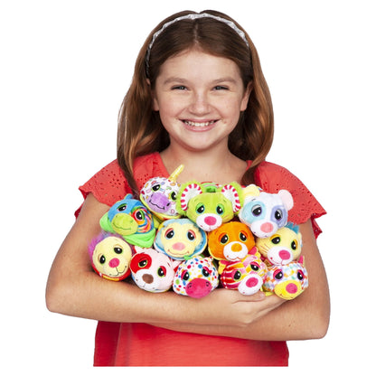 Child modeled in red shirt holding colorful plush Cutetitos characters with large eyes in various animal designs and bright colors