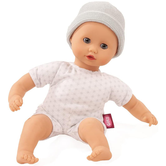 Soft body baby doll wearing grey ribbed cap and white star-print short-sleeve outfit, sitting position on plain white background