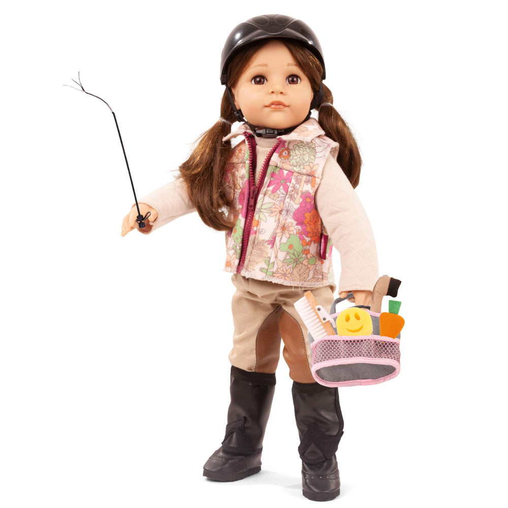 Brown-haired doll modeled by child wearing brown cap, pink floral vest, white long-sleeve shirt, tan pants, and black boots, holding fishing rod and pink basket