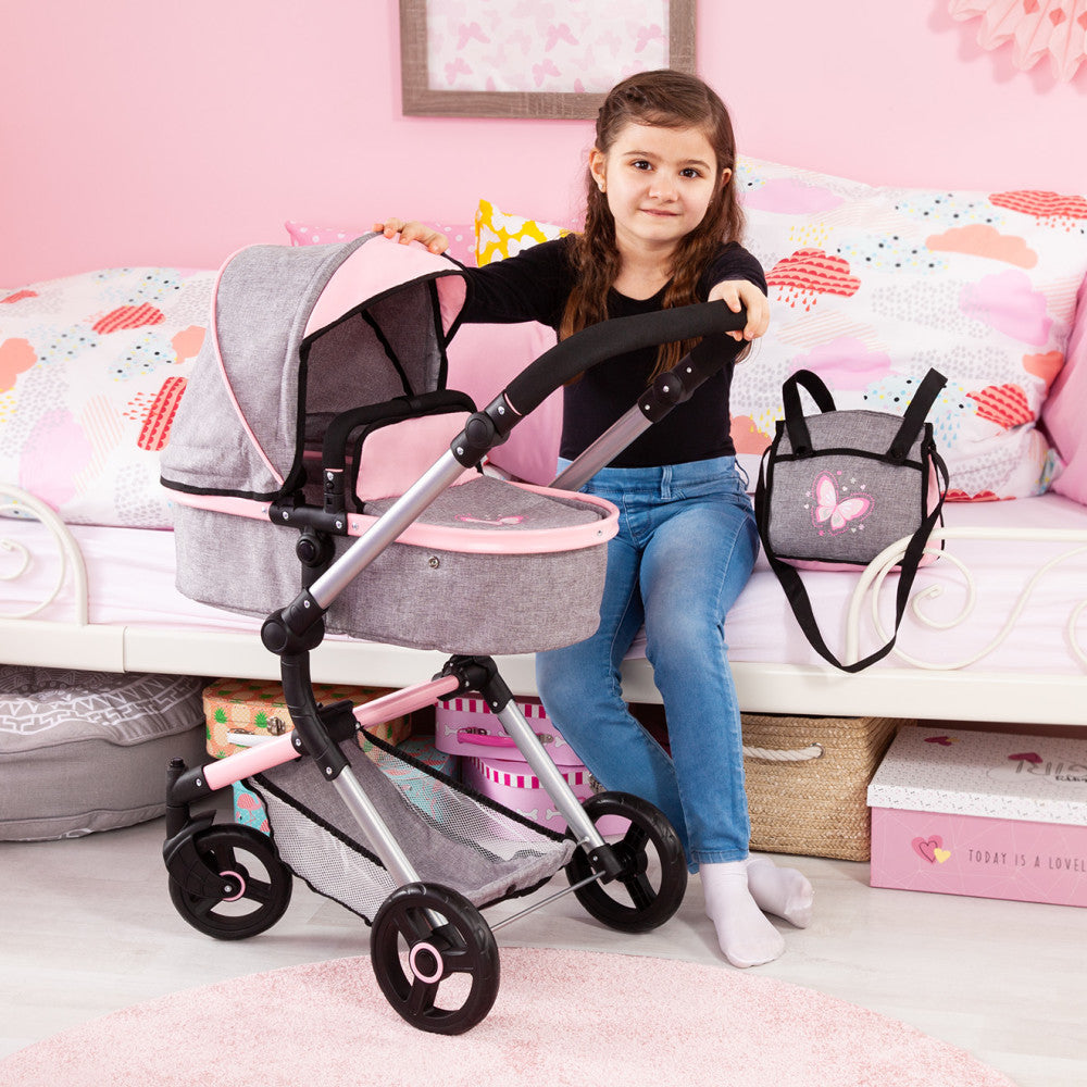 Child on model with gray and pink doll pram and pushchair playset, includes matching diaper bag, set in bedroom with pink bedding