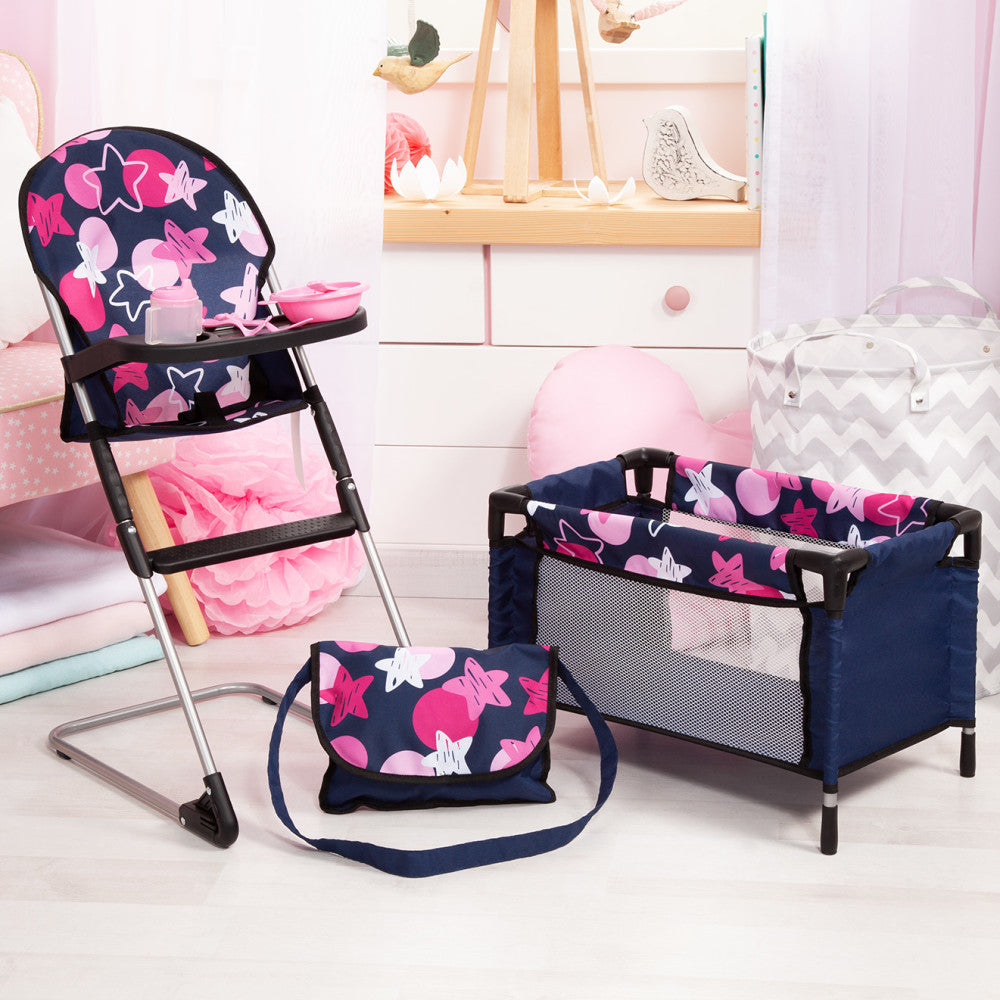 Doll playset with navy and pink star-patterned high chair, portable bassinet, diaper bag, and accessories on pink and white room backdrop