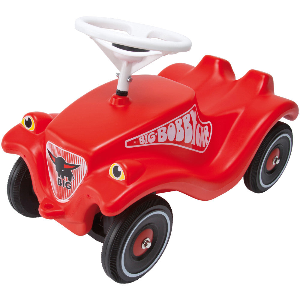 Red BIG Bobby ride-on car with white steering wheel, black wheels, and yellow eye details on plain background