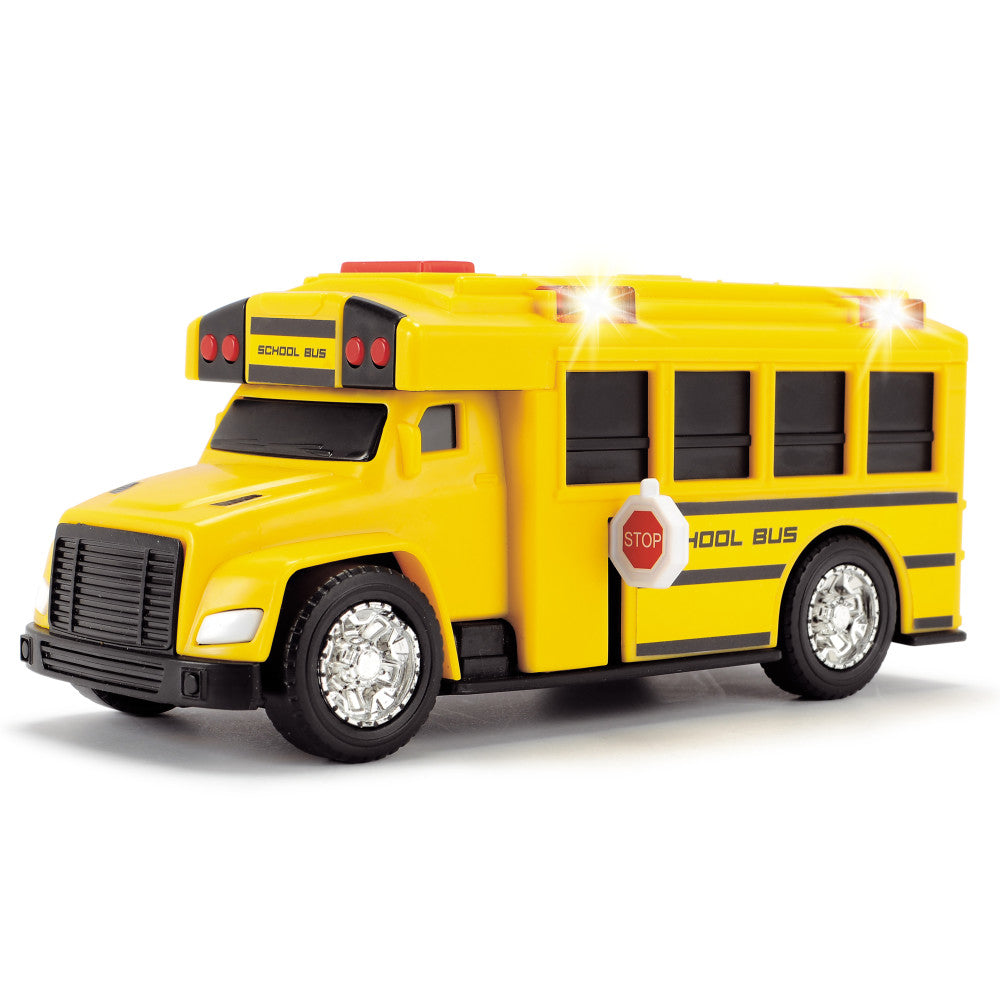 Yellow school bus toy with black details, white wheels, headlights, stop sign, and red roof lights on plain background