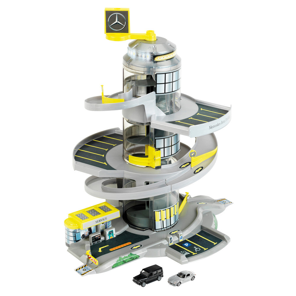 Mercedes-Benz Helix Electric Car Park playset with yellow and gray spiral tower, elevator, multiple parking levels, service station base, and two toy cars