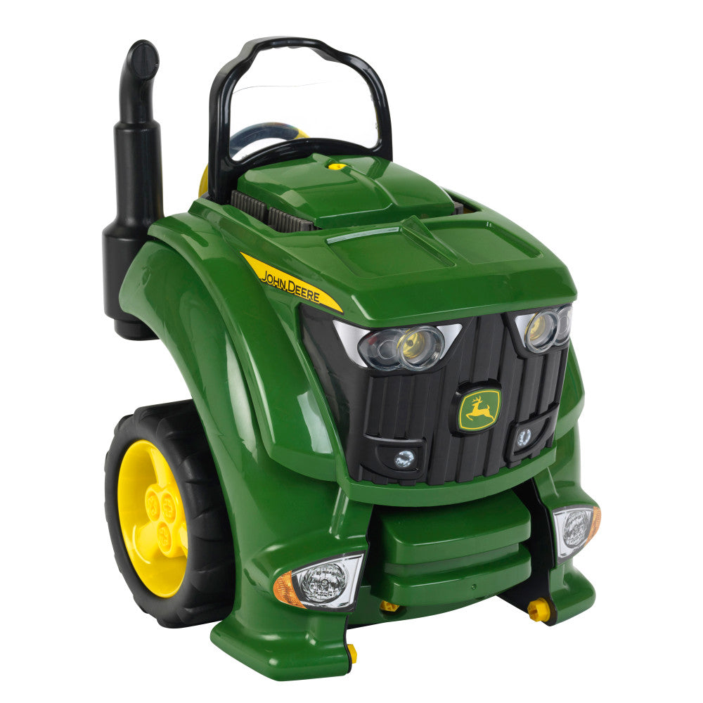 Green and yellow John Deere toy tractor with working headlights, engine compartment, and black antenna on plain background