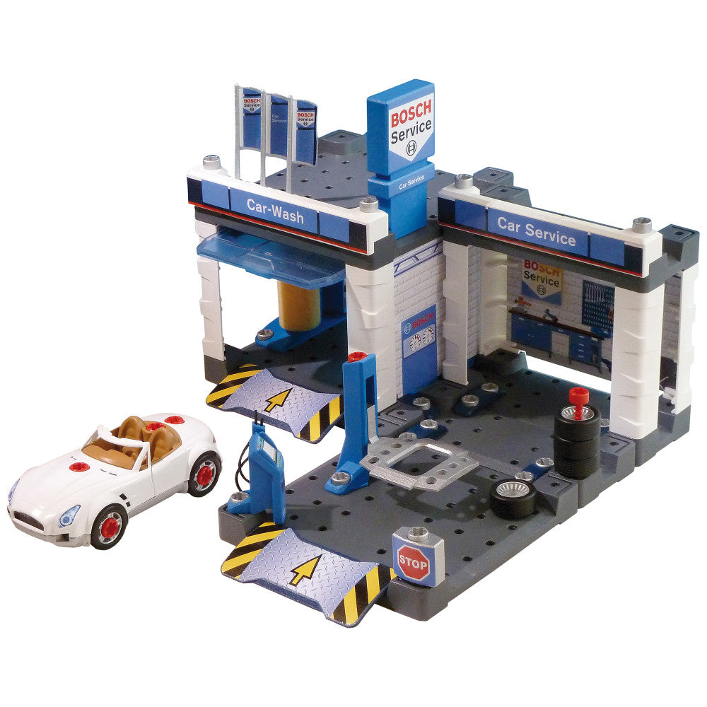 Bosch Service Station playset with car wash and repair shop sections, blue and white building with signage, included white toy car, gas pump, lift, and service