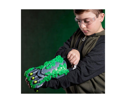 Marvel Doctor Doom Doomglow NERF Triad blaster with green glow-in-the-dark details and yellow darts, held by child we...