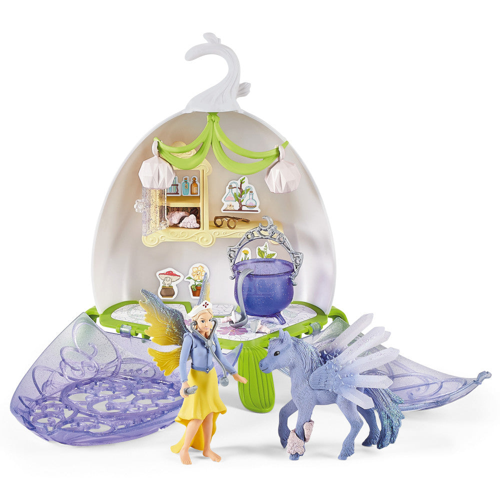 Bayala Magical Vet Blossom playset with fairy figure, winged dragon, cauldron, and shell-shaped house with green canopy and hanging white elements