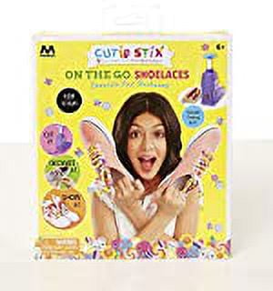 Cutie Stix On the Go Shoes creative kit packaged box showing a child modeling decorated shoelaces with colorful stix accessories on a yellow background