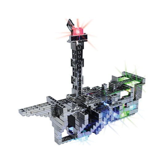 E-blox Power Blox Pro Set building blocks assembled into a futuristic structure with illuminated pink tower, green and blue light-up sections, and track pieces