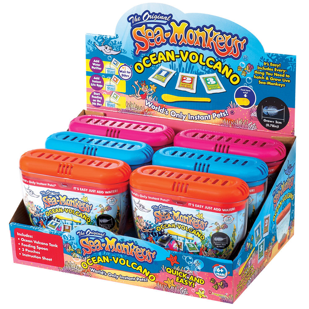 Sea-Monkeys Ocean Volcano Instant Pets display box showing colorful plastic habitat tanks in orange, blue, and pink with instructional packaging and accessories