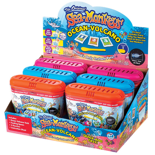 Sea-Monkeys Ocean Volcano Instant Pets display box showing colorful plastic habitat tanks in orange, blue, and pink with instructional packaging and accessories
