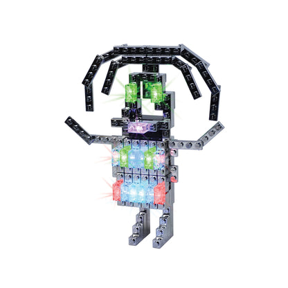 E-blox Power Blox Advanced Set building toy with illuminated colorful blocks in green, blue, pink, and purple arranged in a humanoid figure shape with articulat