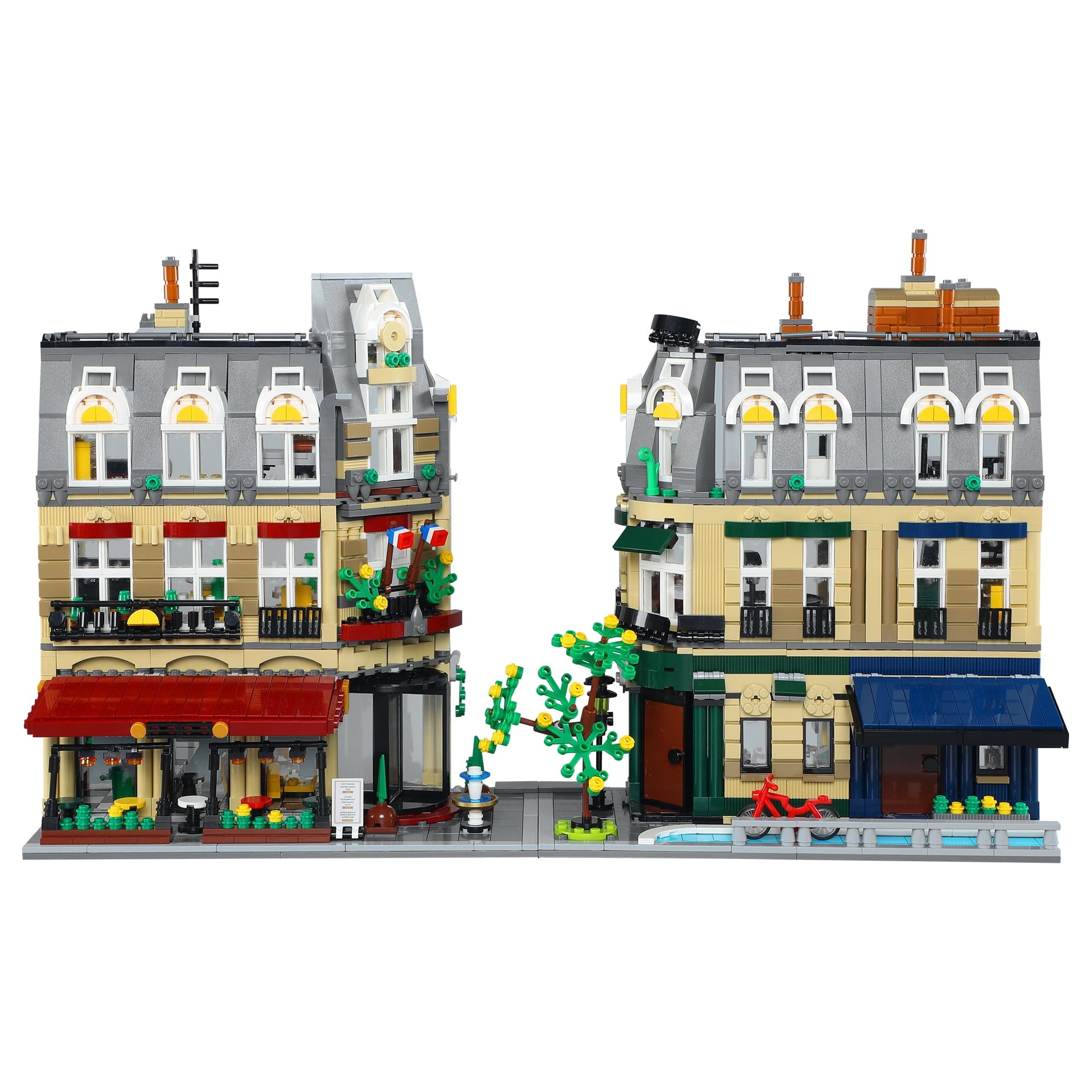 CaDA Parisian Charm building set featuring detailed modular street buildings with gray mansard roofs, yellow-trimmed windows, red storefront awning, green lands