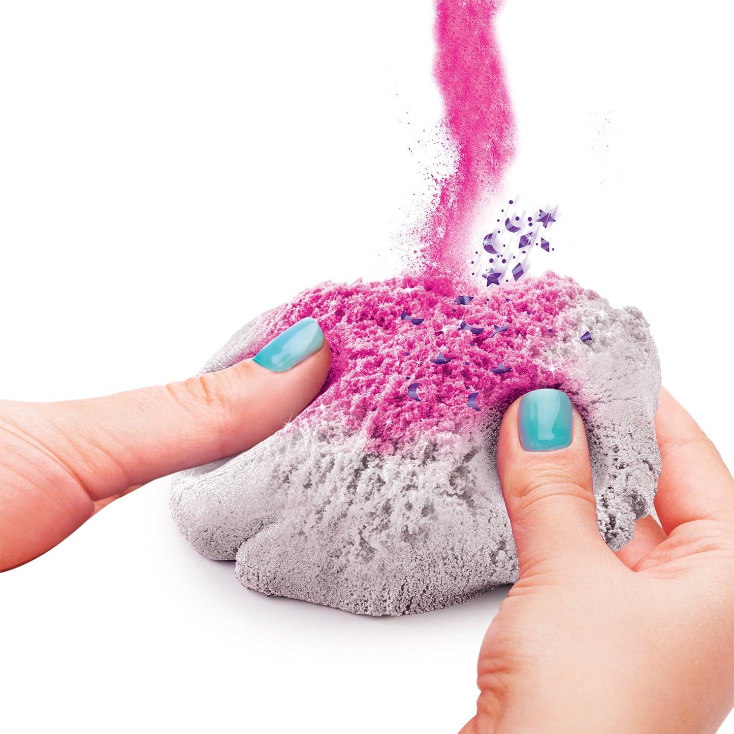 Child's hands squeezing gray and pink kinetic sand, with bright pink sand and purple star-shaped pieces flying up in the air